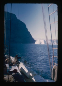 Image of iceberg by mountain through rigging