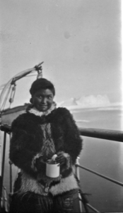 Image of Eskimo [Inuk] woman with mug, on deck