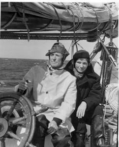 Image of Donald MacMillan in foul weather gear with Miriam MacMillan at wheel