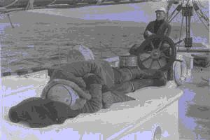 Image of Crewman sleeping on deck, another by wheel