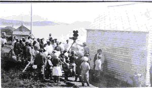 Image of Crowd of Eskimos [Inuit] around movie camera