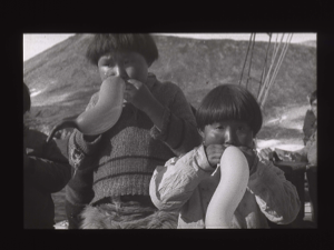 Image of Two Inuit boys with balloons, aboard  [b&w]