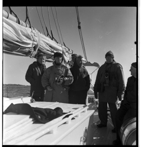 Image of Eskimo [Inuk] pilot and after-deck group, with cameras and warm coats