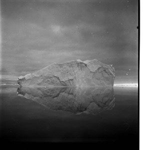 Image: Iceberg with complete reflection under dark sky