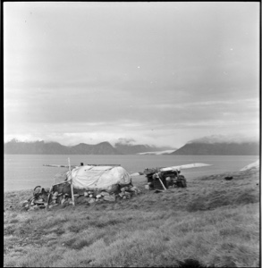 Image of Pond Inlet home, rear view. Kayak on frame