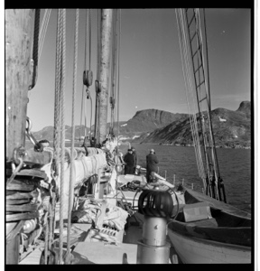 Image of Looking forward along deck. MacMillian and crew at bow