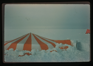 Image of Orange and white tent in snow.
