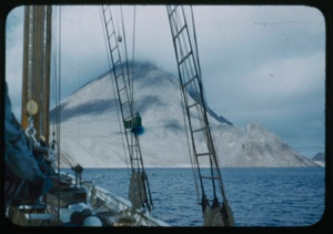 Image of Snow-covered coastal mountain through rigging