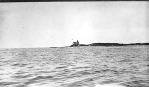 Image of Across water to lighthouse on point