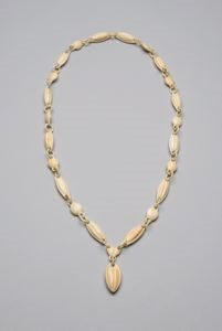 Image: Ivory necklace w/circular loops connecting oblong beads (24 in all), carved from single piece of ivory