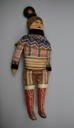 Image of Doll dressed in Sunday best from South Greenland with decorated red boots and beaded collar and cuffs