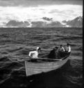 Image of Eskimos [Inuit] in open boat approaching The Bowdoin