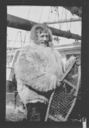 Image of man on deck in furs, with snowshoes 