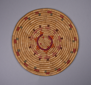 Image: Small round mat with red, blue, purple, orange and brown design