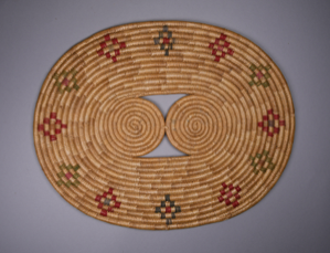 Image: Oval mat with mutli-color design and 2 triangular openings in center
