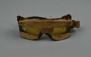 Image of Goggles of yellow glass set into metal rims covered with plush and silk sides