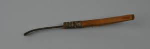 Image of Crooked knife with metal blade and wooden handle, rawhide lashings