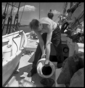 Image: Bill Powers pouring water (from water can, on deck)
