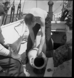 Image of Bill Powers pouring water (from water can, on deck)