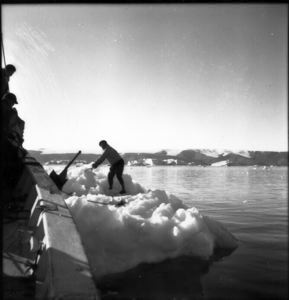 Image of Crewman on ice against the BOWDOIN 