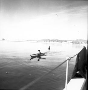 Image of Eskies [Inuit] in kayaks, Inglefield Fjord