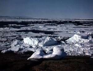 Image: Small icebergs and ice pack. Ice grinding on granite.