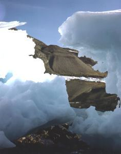 Image of Iceberg. Raised beach beyond.