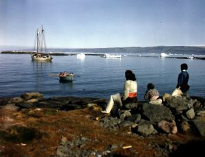 Image of Eskimos [Inuit] on shore watching The Bowdoin.