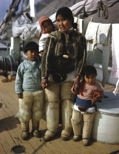 Image of Eskimo [Inuit] woman and three children aboard