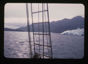 Image of iceberg and mountain through rigging