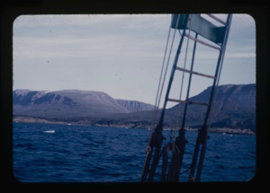 Image of coastline through rigging