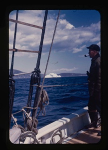 Image of Al Barnes on deck. Iceberg through rigging
