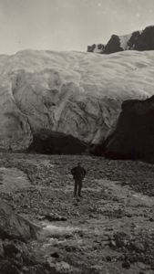 Image of Man looking at nearby glacier