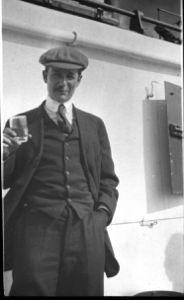 Image of Whitney on deck, holding glass