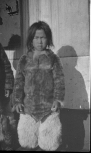 Image of Eskimo [Inuk] boy on deck wearing polar bear pants