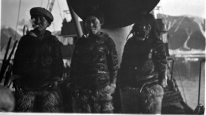 Image of Three Eskimo [Inuit] boys on deck- with cigarette, pipe, cigar