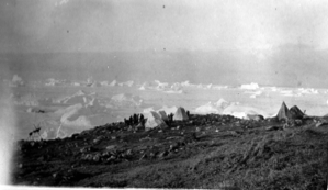 Image of Eskimos [Inuit] near tents