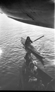 Image: Eskimos [Inuit] in boat and kayak by ship's stern