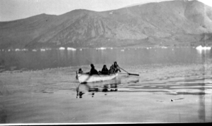 Image of Eskimos [Inuit] in an open boat, with long oars