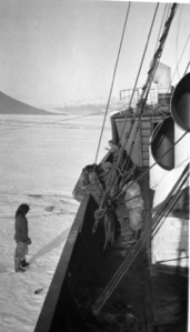 Image of The "Beothic" crew at rail; Inuit on ice below