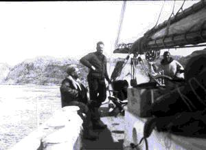 Image of Dr. Potter, Bob Waite, and One-eyed Bobby on board the anchored Bowdoin
