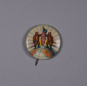 Image: Lapel pin: printed image of 2 fur clad men holding an American flag atop the glo