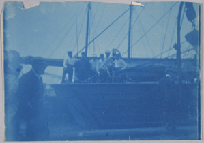 Image of Group of men on vessel at dock, cyanotype