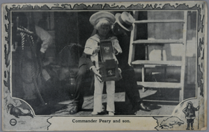 Image of Peary and son on deck, with camera