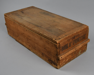 Image of wooden crate with MacMillan's name penciled on top 