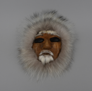 Image of caribou skin mask, man with white beard 