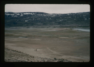 Image: View of raised delta, Centrum Lake. 2 men exploring orientation of runway