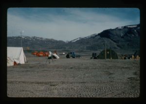 Image of Centrum Lake base camp including 2 US helicopters and vehicles.