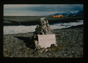 Image: Official cairn on Cape Morris Jesup.  US Army helicopters in background.