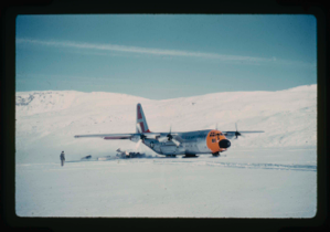 Image of C-130 ski-wheeled aircraft lands personnel and equipment on snow at Centrum Lake